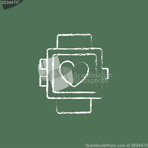 Image of Smartwatch with heart sign icon drawn in chalk.