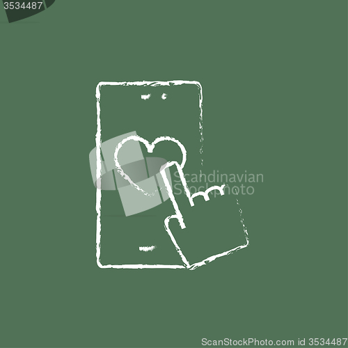 Image of Smartphone with heart sign icon drawn in chalk.