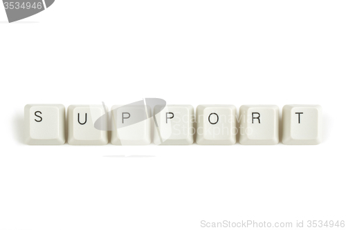 Image of support from scattered keyboard keys on white