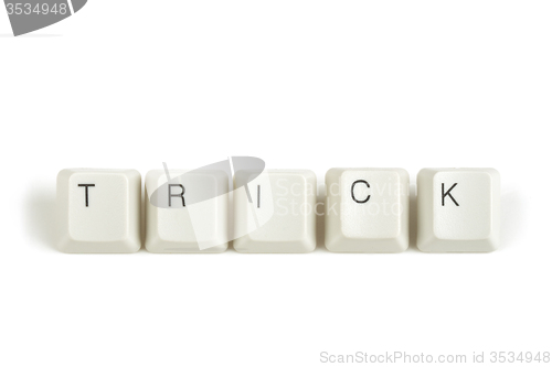 Image of trick from scattered keyboard keys on white