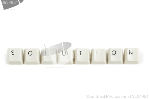 Image of solution from scattered keyboard keys on white