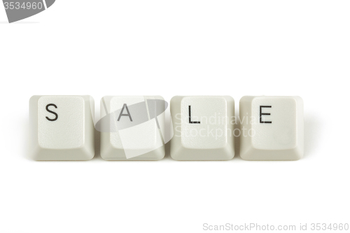 Image of sale from scattered keyboard keys on white