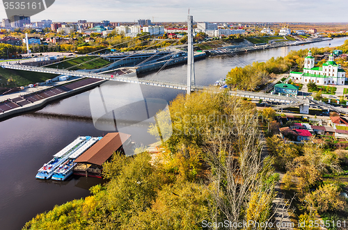 Image of Pedestrian Lovers Bridge on Tura river. Tyumen