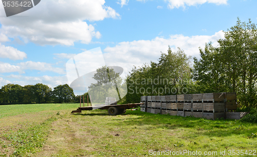 Image of Farm trailer and wooden fruit crates ready for harvest