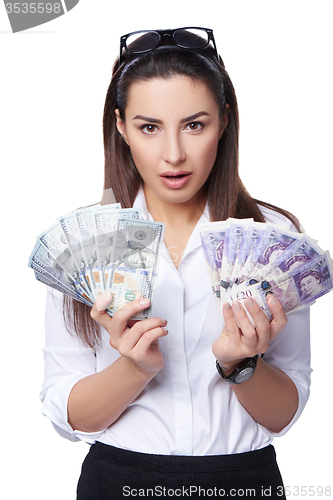 Image of Business woman holding British pounds and US dollars