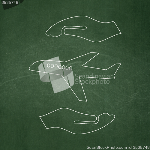 Image of Insurance concept: Airplane And Palm on chalkboard background