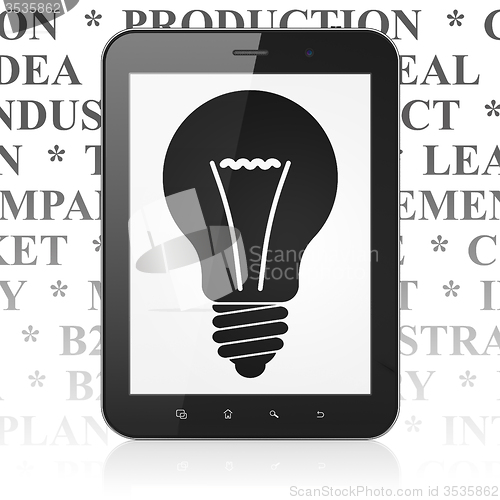 Image of Finance concept: Tablet Computer with Light Bulb on display