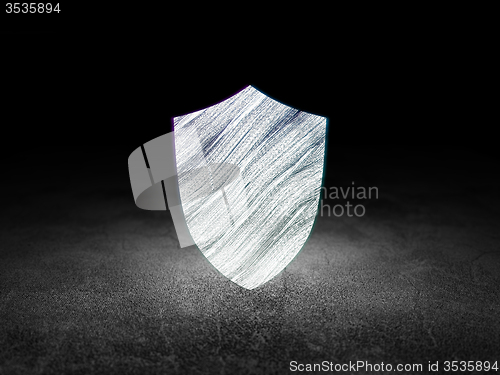 Image of Security concept: Shield in grunge dark room