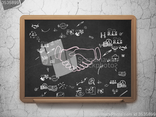 Image of Finance concept: Handshake on School Board background