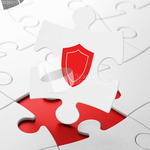 Image of Privacy concept: Shield on puzzle background