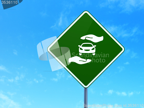 Image of Insurance concept: Car And Palm on road sign background