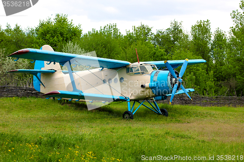 Image of Old retro airplane on green grass 