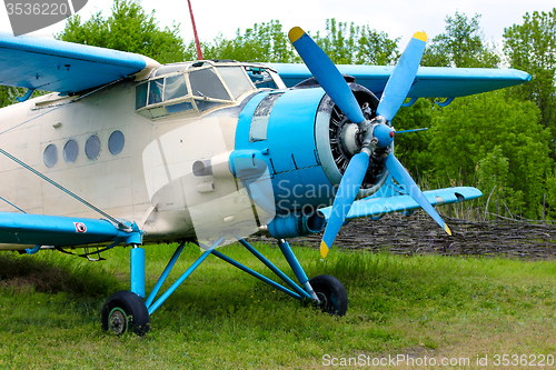 Image of Old retro airplane on green grass 