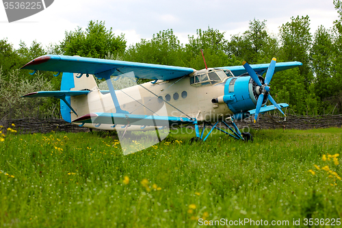 Image of Old retro airplane on green grass 