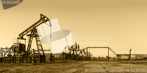 Image of Oil pumps on a oil field.