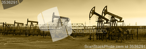 Image of Oil pumps on a oil field.