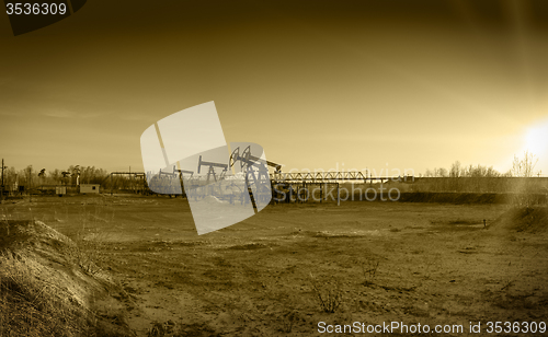 Image of Oil pumps on a oil field.