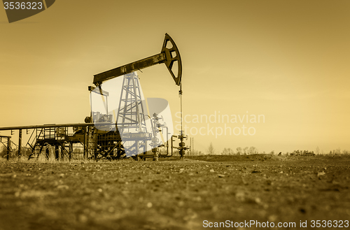 Image of Oil pump on a oil field.