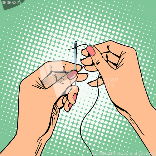 Image of Needlework seamstress threads the needle