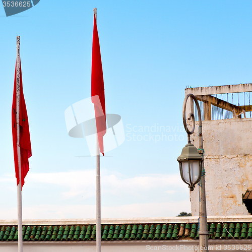 Image of tunisia  waving flag in the blue sky  colour and battlements  wa