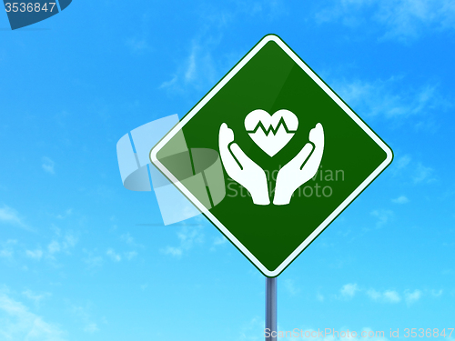 Image of Insurance concept: Heart And Palm on road sign background