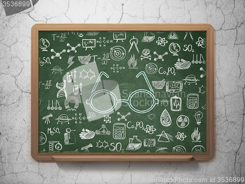 Image of Science concept: Glasses on School Board background