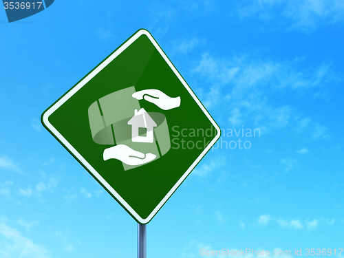 Image of Insurance concept: House And Palm on road sign background