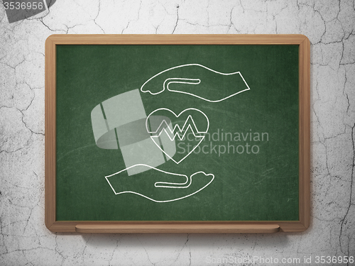 Image of Insurance concept: Heart And Palm on chalkboard background