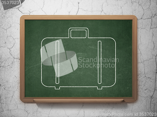 Image of Travel concept: Bag on chalkboard background