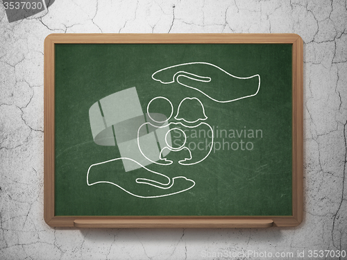 Image of Insurance concept: Family And Palm on chalkboard background