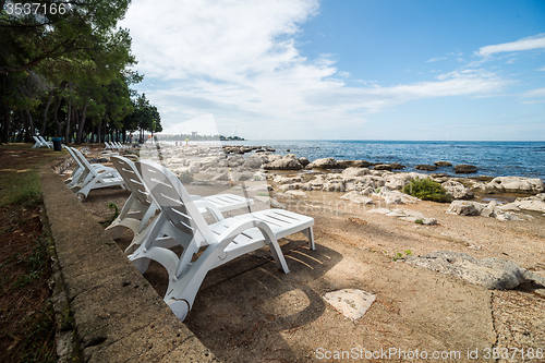 Image of loungers on the rocky beach