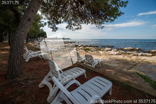 Image of loungers on the rocky beach