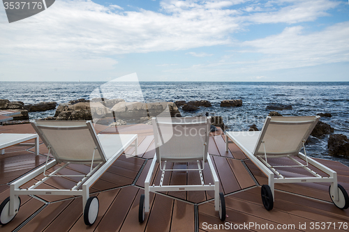 Image of loungers on the rocky beach