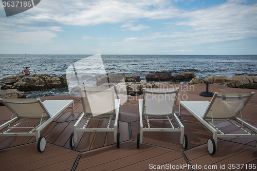 Image of loungers on the rocky beach