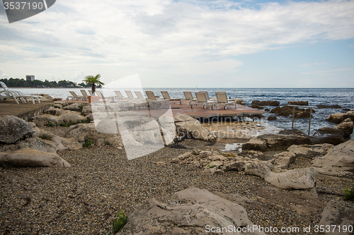 Image of loungers on the rocky beach