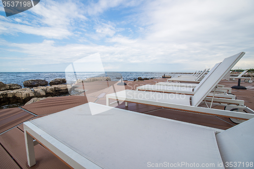 Image of loungers on the rocky beach