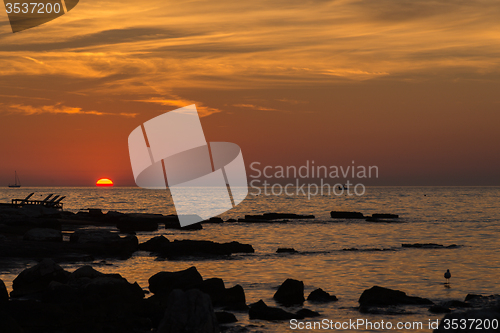 Image of gorgeous sunset on the rocky coast of Adriatic