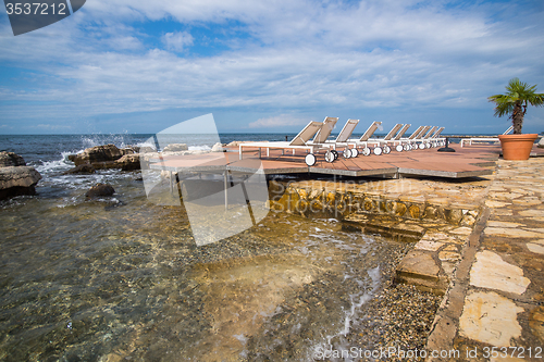 Image of loungers on the rocky beach