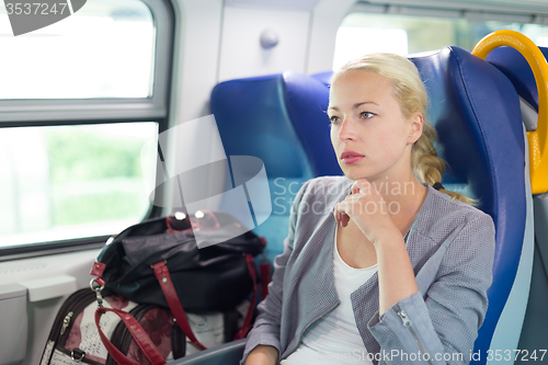 Image of Blonde business woman traveling by train.