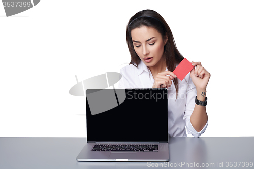 Image of Business woman with laptop showing credit card