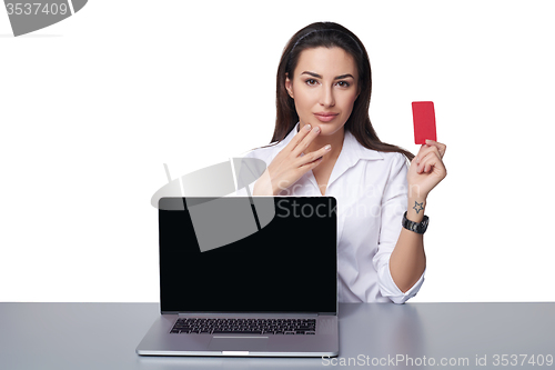 Image of Business woman with laptop showing credit card