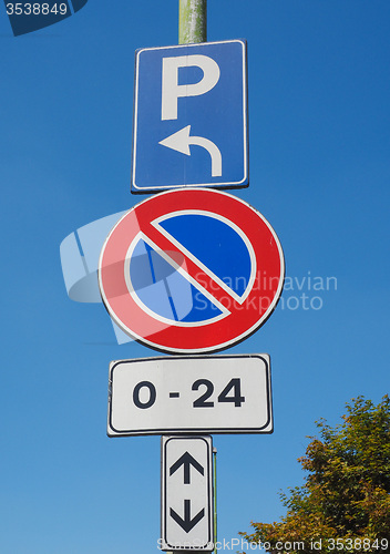 Image of No parking sign over blue sky