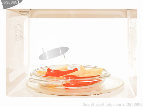Image of Retro looking Microwave with peppers