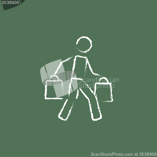 Image of Man carrying shopping bags icon drawn in chalk.