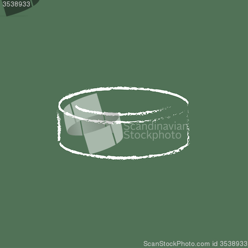 Image of Hockey puck icon drawn in chalk.