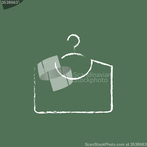 Image of Sweater on hanger icon drawn in chalk.