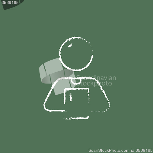Image of Man holding a touchscreen tablet icon drawn in chalk.