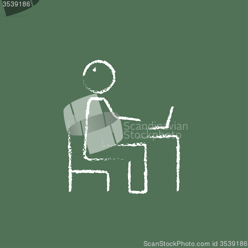 Image of Businessman working at his laptop icon drawn in chalk.