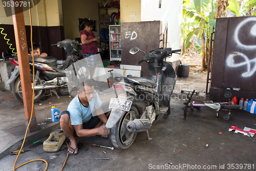 Image of Service man repair deflated damaged tyre