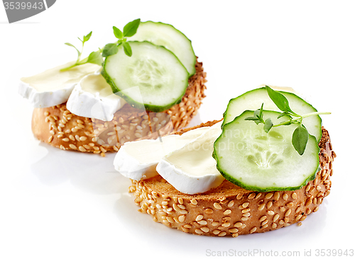 Image of toasted bread with brie and cucumber